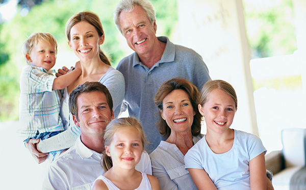 Large multi-generational family smiling